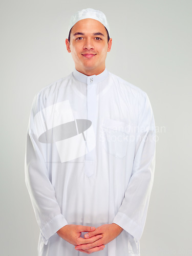 Image of Portrait, muslim and faith with an islamic man in studio on a gray background for religion, belief in god or devotion. Eid, worship and ramadan with a male arab fasting in holy tradition or culture