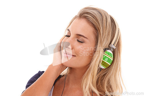 Image of Music, headphones and studio woman listening to radio, audio podcast or playlist song to relax. Hearing, wellness and happy face of model streaming sound for stress relief on white background