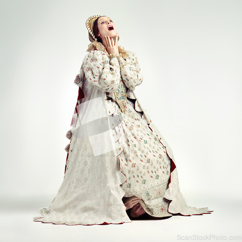 Image of Queen, surprise face and vintage costume in white background for announcement, theatre party dress up or scared character. Woman, shocked and wow for renaissance history event isolated in studio