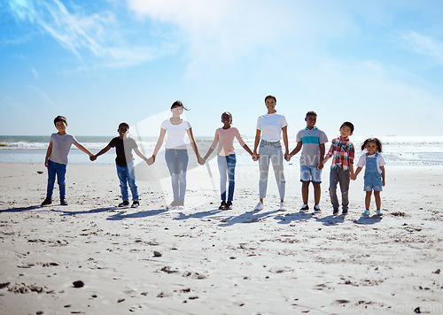 Image of Beach, holding hands and lesbian women with children for support, holiday diversity and big family love in Indonesia. Trust, hope and portrait of parents with kids for a travel vacation at the sea