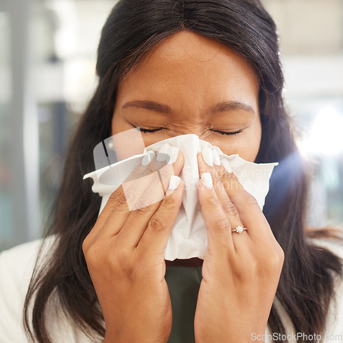 Image of Woman, sneeze and tissue for flu, covid and safety in workplace with hands on face for health by blurred background. Corporate black woman, office and sick with toilet paper, nose and covid 19 virus