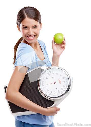 Image of Apple, scale and diet of woman in studio isolated on white background for health, lose weight and portrait. Green fruit, body goals and model smile for her detox results, food commitment and wellness