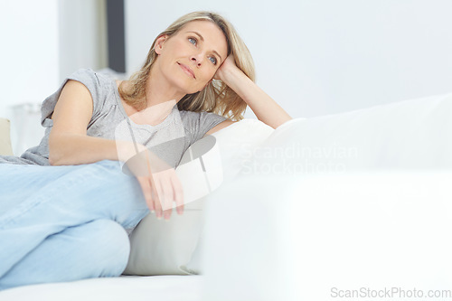 Image of Woman, sofa and relax for thinking, rest and memory in home living room for peace, quiet and mindfulness. Mature lady, couch and sitting for calm reflection in house, lounge or apartment in Australia