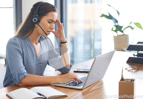 Image of Call center, stress and tired woman working on laptop with headache, burnout and depression consulting at CRM desk. Female with anxiety mental health problem at customer service telemarketing office