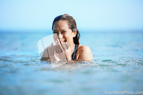 Image of Young woman swimming in ocean, happy on beach vacation and freedom of summer adventure in Mauritius. Female tourist laughing in the water, tropical destination for travel and natural outdoor paradise