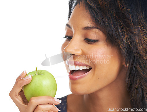 Image of Black woman, studio and apple with diet, lifestyle and hungry for healthy, organic snack and eating by white background. Woman, smile and natural green fruit for detox, energy or wellness by backdrop