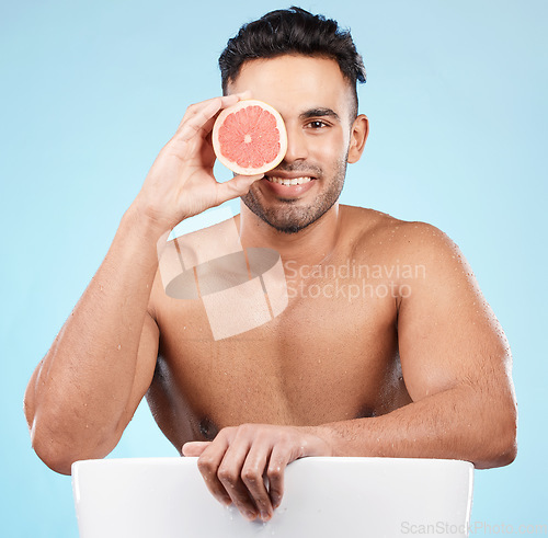 Image of Beauty, health and portrait of man with grapefruit for fruit detox, healthy body or natural facial skincare routine. Wellness spa salon, vitamin c glow and happy nutritionist model with food product