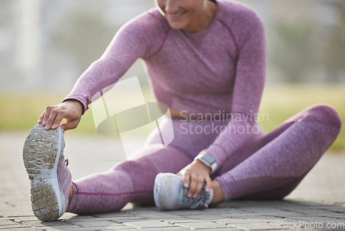 Image of Woman, exercise and fitness while stretching outdoor at a city park for health and wellness with cardio training. Athlete female sitting for warm up workout and running for healthy lifestyle and body