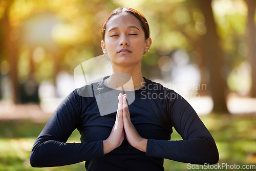 Image of Relax woman, namaste and meditation at park, wellness or freedom of chakra energy, zen fitness or peace. Young girl, yoga exercise and praying with eyes closed, nature and mental health, hope or calm