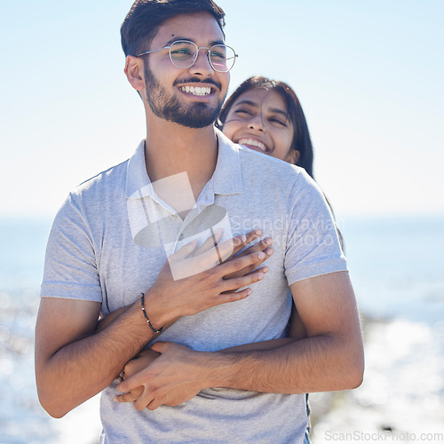 Image of Hug, happy young couple at beach with travel and care on summer holiday by ocean, commitment and support outdoor. Partner, embrace and relationship with romantic date, man and woman on vacation
