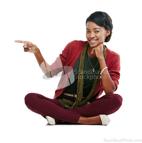 Image of Black woman, smile portrait and pointing finger, relax sitting isolated in white background for advertising mockup. African girl, happy and point for marketing, product placement or idea vision