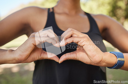 Image of Hands, fitness or black woman in nature with heart sign in training, exercise or park workout in summer. Love, zoom or healthy African sports girl with hope, goals or loving hand gesture in Nigeria