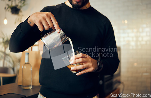 Image of Coffee, milk and hands of man in cafe for cappuccino, breakfast and caffeine beverage. Relax, espresso and dairy with barista in coffee shop and with latte for retail, mocha and drink preparation