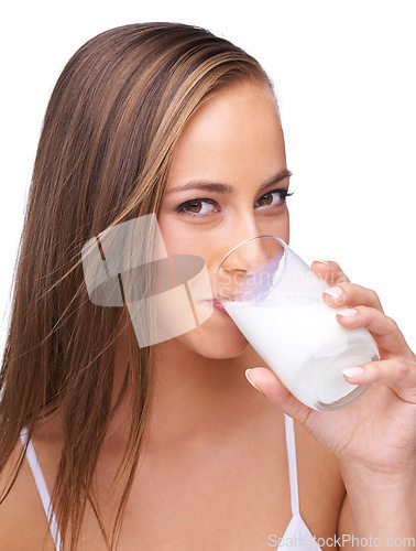 Image of Milk, drink and portrait of woman on studio, isolated white background and healthy diet. Face of female model, glass and dairy for breakfast, nutrition and dairy with protein, vitamins and calcium