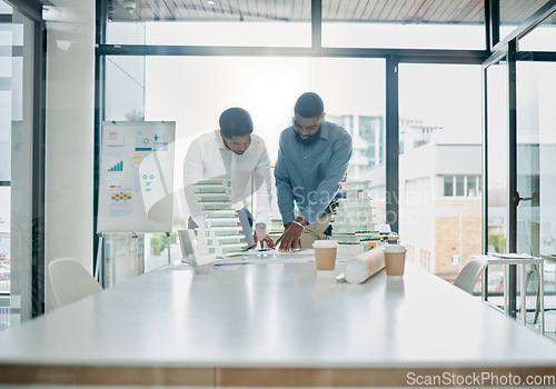 Image of Planning, building model and architecture team analyzing a construction blueprint in an office. Teamwork, collaboration and industrial workers working on real estate development with 3d design.