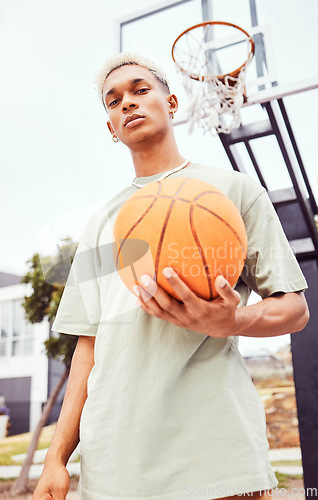 Image of Sports, basketball court and a portrait of man with ball outside at park. Exercise, motivation and workout for fitness, wellness and health. Street game, outdoor basketball training and serious face.