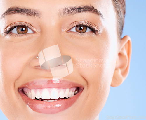Image of Teeth, dental and face portrait of woman with clean smile, teeth whitening and oral self care on blue background. Tooth implant, healthcare and beauty model with makeup, cosmetics and facial skincare