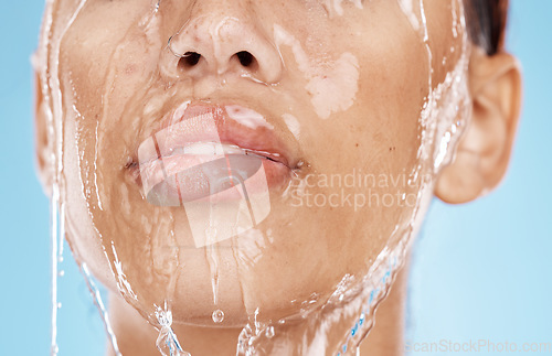 Image of Woman, washing face or water drops skincare on blue background studio in lips healthcare wellness, hygiene cleaning or mouth moisture grooming. Zoom, beauty model or facial water splash in wet shower