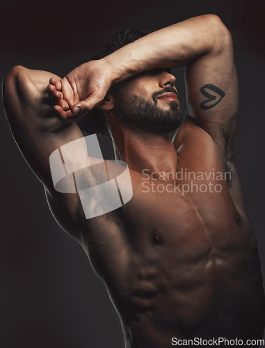 Image of Man, body or muscle on black background in studio for fitness goals, workout or training motivation and physical wellness check. Bodybuilder, sports athlete or model flexing on aesthetic backdrop