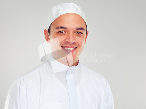 Image of Portrait, muslim and religion with an islamic man in studio on a gray background for faith, belief in god or devotion. Eid, worship and ramadan with a male arab fasting in holy tradition or culture