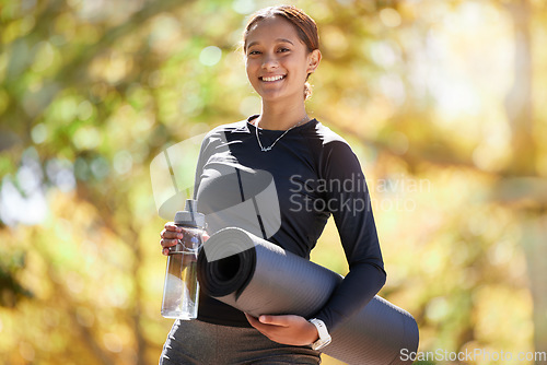 Image of Portrait, exercise and woman with water bottle, fitness and workout for wellness, health and in park. Latino female girl and athlete with yoga mat, hydration and training for cardio, energy or sports