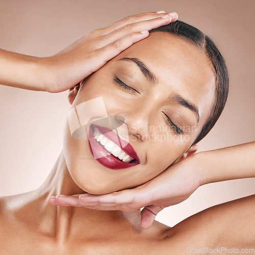 Image of Face, beauty and woman with lipstick, hands frame and cosmetic care for lips, makeup against studio background. Teeth, dental and skincare wellness with cosmetics product, smile and microblading