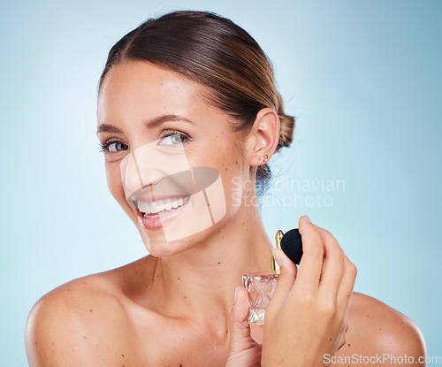 Image of Perfume, portrait or woman in studio with a happy smile grooming or relaxing with a fragrance sprayer. Mockup space, advertising or beautiful girl model with marketing a perfume bottle for self care