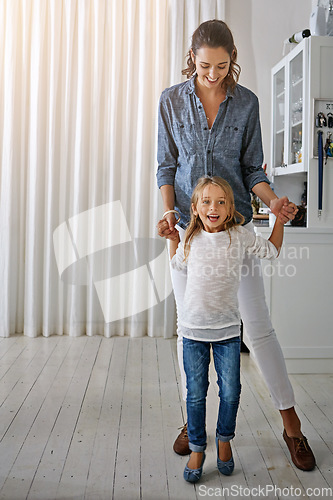 Image of Playful, happy and portrait of a mother and child with quality time in the living room of a house. Smile, happiness and girl playing with her mom in the lounge of their home together on the weekend
