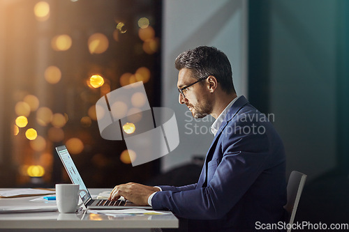 Image of Night, corporate and man typing, focus and digital marketing for website launch, connection and workplace. Male employee, leader and entrepreneur working late, online reading or thinking for business