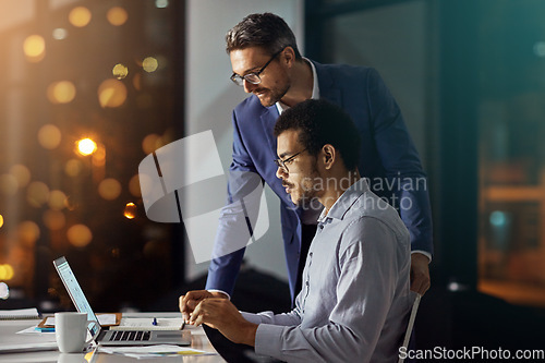 Image of Team, laptop and collaboration working at night in office for business meeting, planning overtime and report deadline. Business people, late and digital tech conversation or web design teamwork