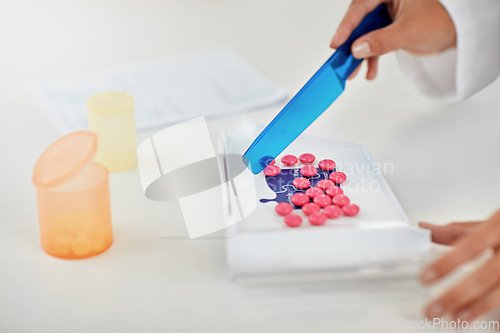 Image of Hands, pharmacist and counting pills for prescription, packaging or inventory at a pharmacy. Hand of doctor working with medication tablets or pharmaceutical drugs for healthcare on counter at clinic