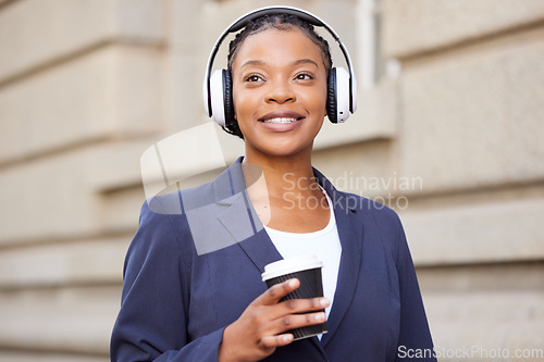 Image of Business woman, headphones and music with coffee outdoor, travel to work or coffee break with podcast or radio. Black woman on commute, listening with technology and audio streaming in the city.