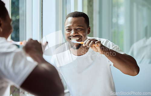 Image of Morning, happy and black man brushing teeth in bathroom for health, hygiene and clean smile. Self care, cleaning and oral hygiene for healthy teeth of person smiling with confidence in home.