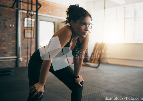 Image of Fitness, exercise and woman tired at gym after a workout or training for health and body wellness. Young sports female or athlete resting on break while thinking about goals, progress and performance