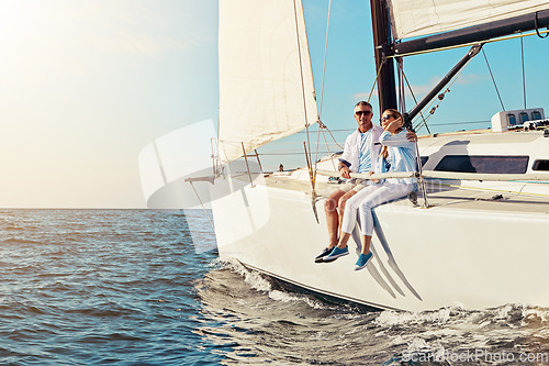 Image of Yacht, travel or love and a mature couple sitting on a boat out at sea with blue sky mockup and flare. Ocean, summer and luxury with a man and woman on a ship to relax on the water in nature