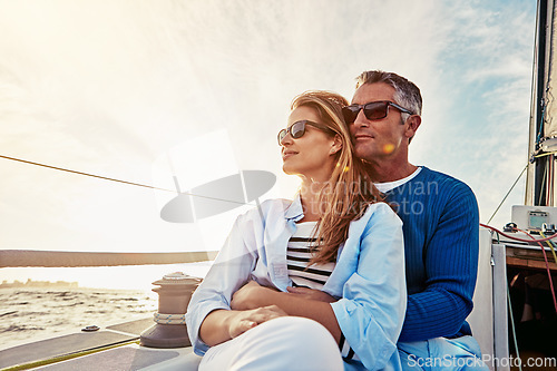 Image of Yacht, travel and love with a mature couple sitting together on a boat out at sea for a romantic date. Luxury, ocean or summer with a married man and woman on a ship to relax during a trip