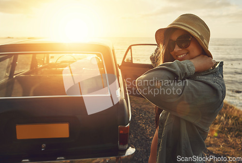 Image of Woman, road trip and smile for sunset travel, vacation or journey with a view of the ocean in outdoor nature. Happy female traveler smiling in happiness for summer with lens flare for a beach drive