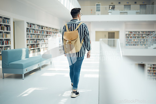 Image of Backpack, library and education with a man student walking in a university bookstore for learning or development. Back, college and research with a male pupil taking a walk in search of a book