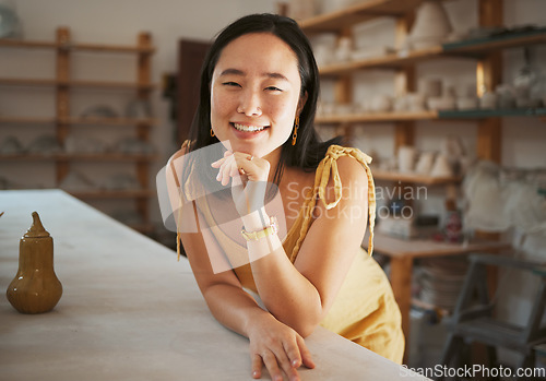 Image of Asian woman, success portrait and ceramic workshop or art studio for product manufacturing, sculpture artist and creativity retail store. Pottery, artistic woman face and happy creative artwork