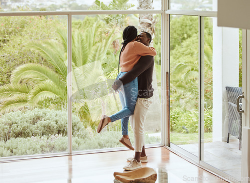 Image of Black couple, hug and love while happy together in their new house with love and happiness to celebrate anniversary or home. Young man and woman with support, care and joy in a healthy marriage