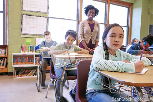 Image of Learning, kids and student portrait in classroom with notebook for lesson notes and knowledge. School kids, education and development of middle school children writing in books with happy teacher