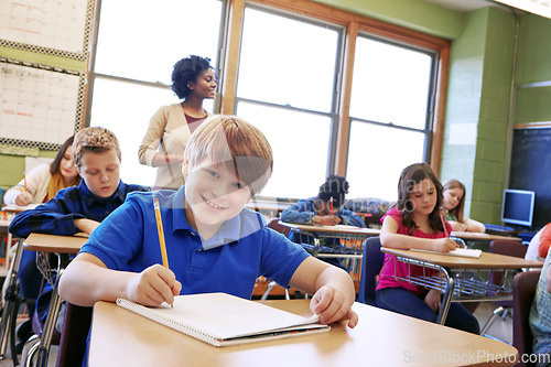 Image of School, children and education portrait in a classroom while writing to learn, study and gain knowledge. Boy and girl group students in class while learning for future, development and growth