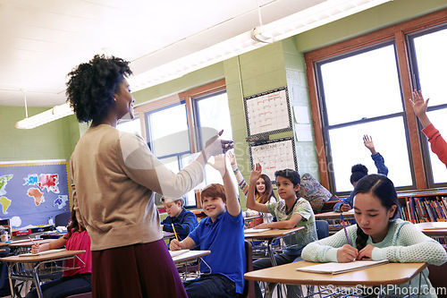 Image of Teacher, students and classroom with hands for question, answer or FAQ of engaging children. Happy female educator teaching enthusiastic kids for learning, education or development in class