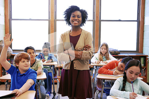 Image of Portrait, student question and black woman teacher in classroom or middle school. Education, arms crossed or boy raising hand to answer questions, studying or learning help with happy female educator
