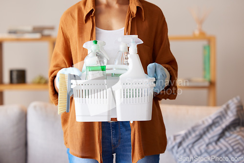 Image of Cleaning, hygiene and detergent with a woman holding a basket of products as a cleaner in a home. Bacteria, container and spray bottle with a female housekeeper ready to clean with disinfectant