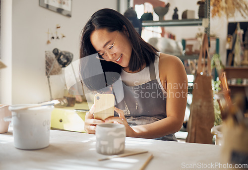 Image of Phone photo, pottery and woman at a studio for art entrepreneurship, social media update and creative job. Small business, creativity and girl with a mobile picture of professional clay work