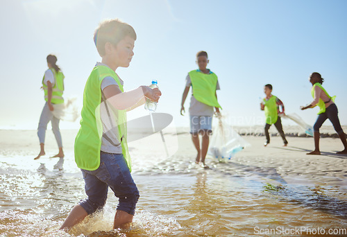 Image of Plastic recycling, children and beach cleaning for eco friendly sustainability, teamwork and global conservation. Waste recycle project, youth team action and fun in ocean for sea pollution clean up