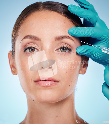 Image of Plastic surgery, skincare and woman with injection, healthcare and on blue studio background. Female, girl and botox with cosmetics, wellness and face care for health, soft and smooth skin for beauty
