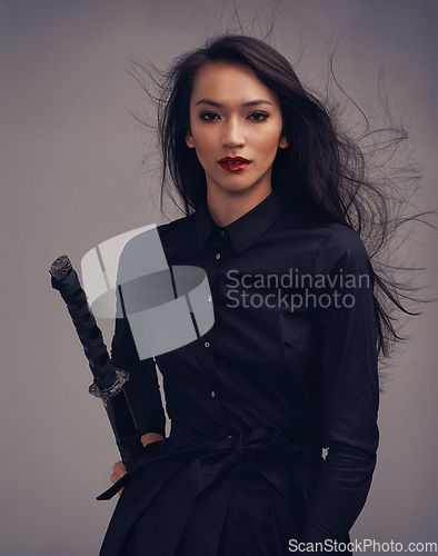 Image of Fashion, beauty portrait and warrior woman art with sword to fight for power, cosplay and fantasy. Strong asian female from Japan in black for makeup and cosmetics for samurai or ninja battle