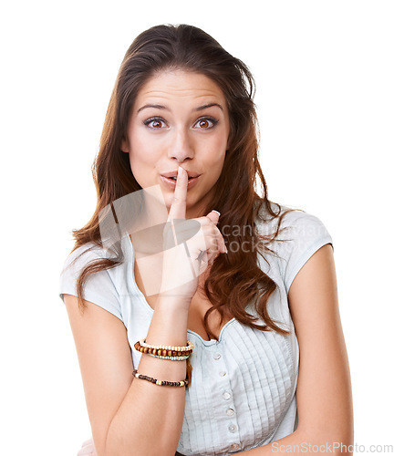 Image of Portrait, secret and a woman with her finger on lips in studio on a white background for gossip. Face, whisper and confidential with an attractive young female being quiet with a hand sign or gesture